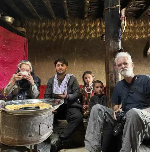 Visitors and local people sharing a meal